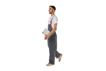Tech in overalls walks with a tablet, isolated on white, PNG