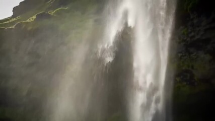 Waterfall landscape, natural rock formation with flowing water and moss. Scenic nature background, travel adventure, natural wonders and exploration.