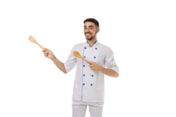 Chef smiles, holding spatula and spoon, isolated on white, PNG
