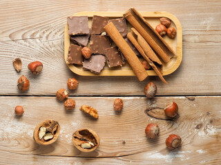 walnuts and hazelnuts,cinnamon, chocolate with nuts, background, Christmas wallpaper on a wooden countertop