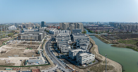 Obraz premium Aerial view of a large construction site with buildings under construction near river.