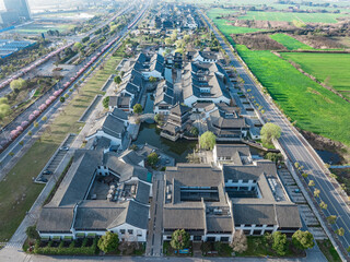 Aerial view of ancient chinese architecture buildings with grey roof tiles and water.
