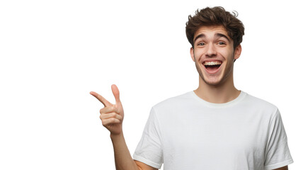 Young man smiles broadly and points to the side in a cheerful manner on a plain white background.