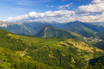 Naklejka premium Col d'Aspin winding road among green Pyrenees mountains