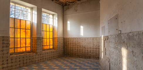 Abandoned Room with Old Yellow Windows and Sunlight