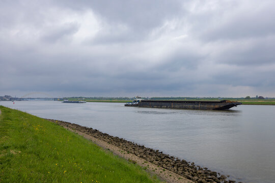 Cargo barge navigating Oude Maas river in Alblasserdam
