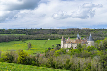 Naklejka premium Chateau de La Rochepot standing among green hills in Bourgogne
