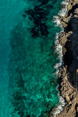 Fototapeta premium Birdview of mediterranean sea water of a lovely coastline- Mallorca best beaches 