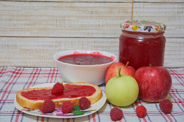 dessert raspberry-apple jam with bread jar of jam and fresh apples with raspberries, rustic sweet breakfast or dessert on a wooden table covered with a tablecloth