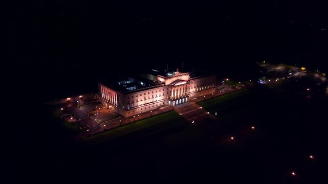 Left-to-right 4K 60 frames per second aerial video of the Stormont Parliament Buildings in Belfast, Northern Ireland on a calm, quiet night. Produced in broadcast standard Rec709 color space.