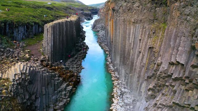 Aerial view of Studlagil Canyon in Iceland. Turquoise glacial river flowing between towering basalt column walls,  thet is one of Iceland&rsquo;s most spectacular natural landscapes.