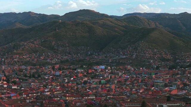 Cusco Cuzco Per&uacute; cityscape aerial drone Vive en el Peru mountain hillside high altitude colorful Inca neighborhood buildings main square Plaza De Armas sunset golden hour blue skies clouds upwards