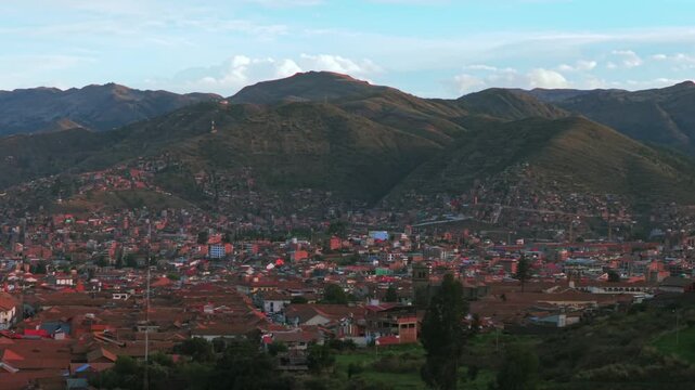 Cusco Cuzco Per&uacute; cityscape aerial drone colorful Inca neighborhood buildings main square Plaza De Armas sunset golden hour blue skies clouds Vive en el Peru mountain hillside high altitude upwards
