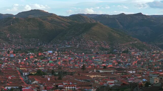 Cusco Cuzco Per&uacute; cityscape aerial drone colorful Inca neighborhood buildings main square Plaza De Armas sunset golden hour blue skies clouds Vive en el Peru mountain hillside high altitude pan left