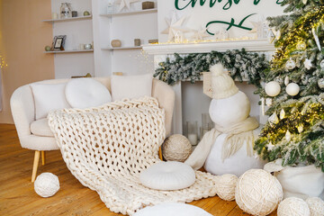 Cozy winter living room with fireplace, decorated Christmas tree, and plush snowman