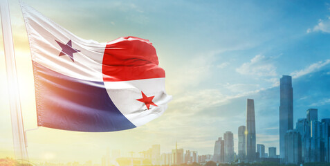 Panama flag wavering in beautiful clouds with building skyline. The flag with drone shot in beautiful sky. Panama national day flag for independence day.