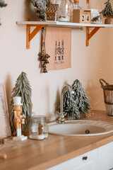Festive kitchen decor with nutcracker soldier, snowy trees, and holiday bells on the counter