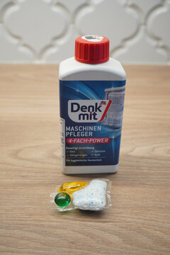 Dishwasher cleaner with cleaning tablets on a wooden surface