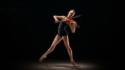 Naklejka premium Violin performance captured mid-air in expressive ballet motion. Concept of body-as-instrument, culture promo visuals, theatre posters, art school materials, dynamic creative movement scenes.