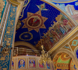 Interior of the Nativity of Christ Cathedral in Chisinau, Moldova: gilded chandelier, decorated iconostasis and dome with Christ .