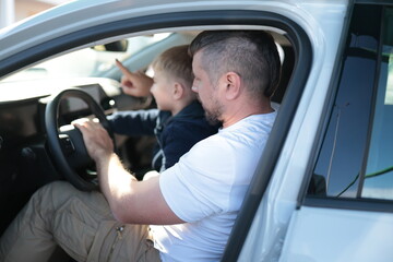 Father and son bonding in car learning driving