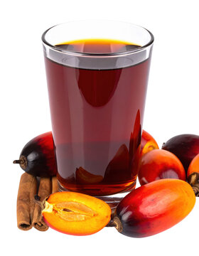Glass of zobo hibiscus drink with a slice of orange and a cinnamon stick garnish, isolated on white background