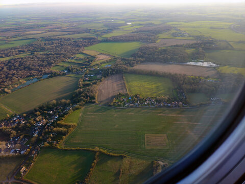 Stansted, London, England, December 30, 2024. View from the plane just after takeoff from Stansted Airport, located in Essex. You can see cultivated fields, wooded areas, and small settlements