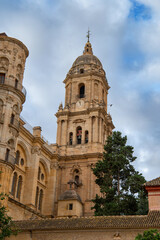 Naklejka premium View of Cathedral of Málaga tower (Santa Iglesia Catedral Basílica de la Encarnación), Malaga , Andalusia, Spain. Roman Catholic church. Religious concept.