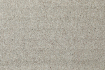 Kraft paper texture, macro close-up. Natural, warm, fibrous surface suitable for use as a background in design and craft projects