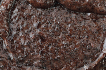 Macro texture of cosmetic coffee scrub with natural grains. Perfect background for beauty, skincare, spa, cosmetic, and wellness design projects