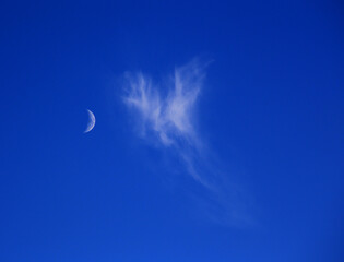 Backgrounds. Concepts. Cloudscape. Deep blue sky with beautiful cirrus and cirrostratus clouds and moon. Portugal.