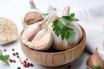 Garlic, peppercorns and parsley on white table, closeup