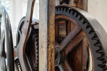 Close-up of rusty metal gears and wooden frame on vintage machine