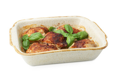 Tasty cooked chicken thighs with basil in baking dish isolated on white