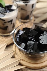 Tasty herbal jelly with milk and mint served on wooden table, closeup