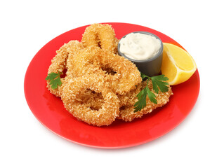 Deep fried squid rings with parsley, sauce and slice of lemon isolated on white