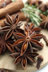 Mulled wine spices. Anise stars, cinnamon sticks, cloves and fresh rosemary on table, closeup