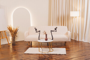 Podcast recording setup with microphones on a stylish table in a cozy room with natural decor