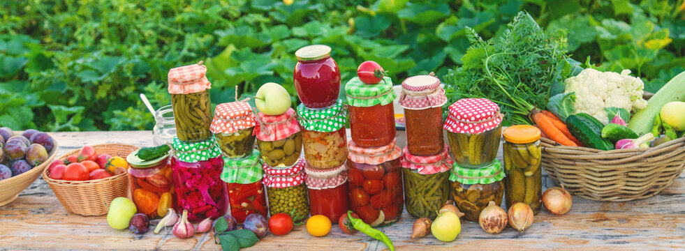 Jars with preserved vegetables for the winter. Selective focus. - Powered by Adobe