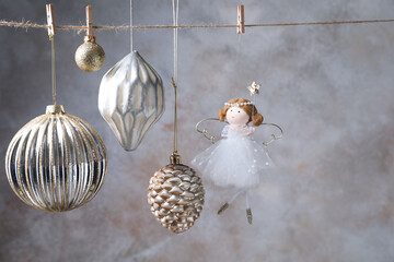 Fototapeta premium Beautiful Christmas decor hanging on string near light grey wall. Space for text