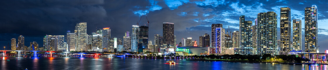 Fototapeta premium Miami skyline with skyscrapers real estate by the ocean at night panorama in downtown Miami, United States