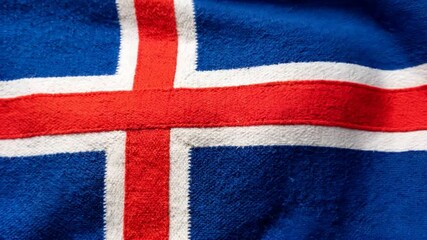 Icelandic national flag waving in the wind, top-down overhead view, blue field with red and white Nordic cross fluttering, patriotic seamless video background