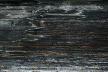 Naklejka premium Old rural wooden facade with charred planks and weathered texture