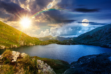 beautiful scenery with alpine lake. day and night time change concept. gorgeous clouds over the distant mountain ridge with sun and moon. steep grassy slopes with rocks. equality and shift template