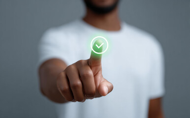Digital composite of an unrecognizable black man touching green checkmark icon with his finger to show approval, agreement, and success in business context