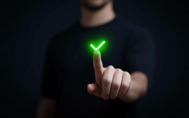 Close up of businessman hand touching glowing green checkmark icon on dark background showing successful completion of task or approval and agreement with confident and positive feeling