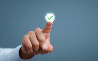 Closeup hand touching green check mark icon on virtual screen interface showing successful approval or completed task with correct choice and decision