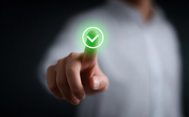 Businessman hand touching green checkmark icon for quality assurance and approved standard compliance, confirming successful correct digital validation on virtual screen