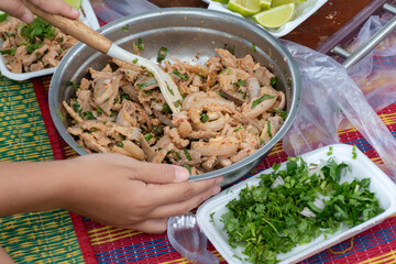 Junior Red Cross students making Isaan pork larb during their outdoor camping trip.