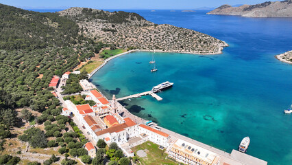 Aerial drone photo of iconic bay and holy Monastery of Archangel Michael Panormitis, Symi island,...